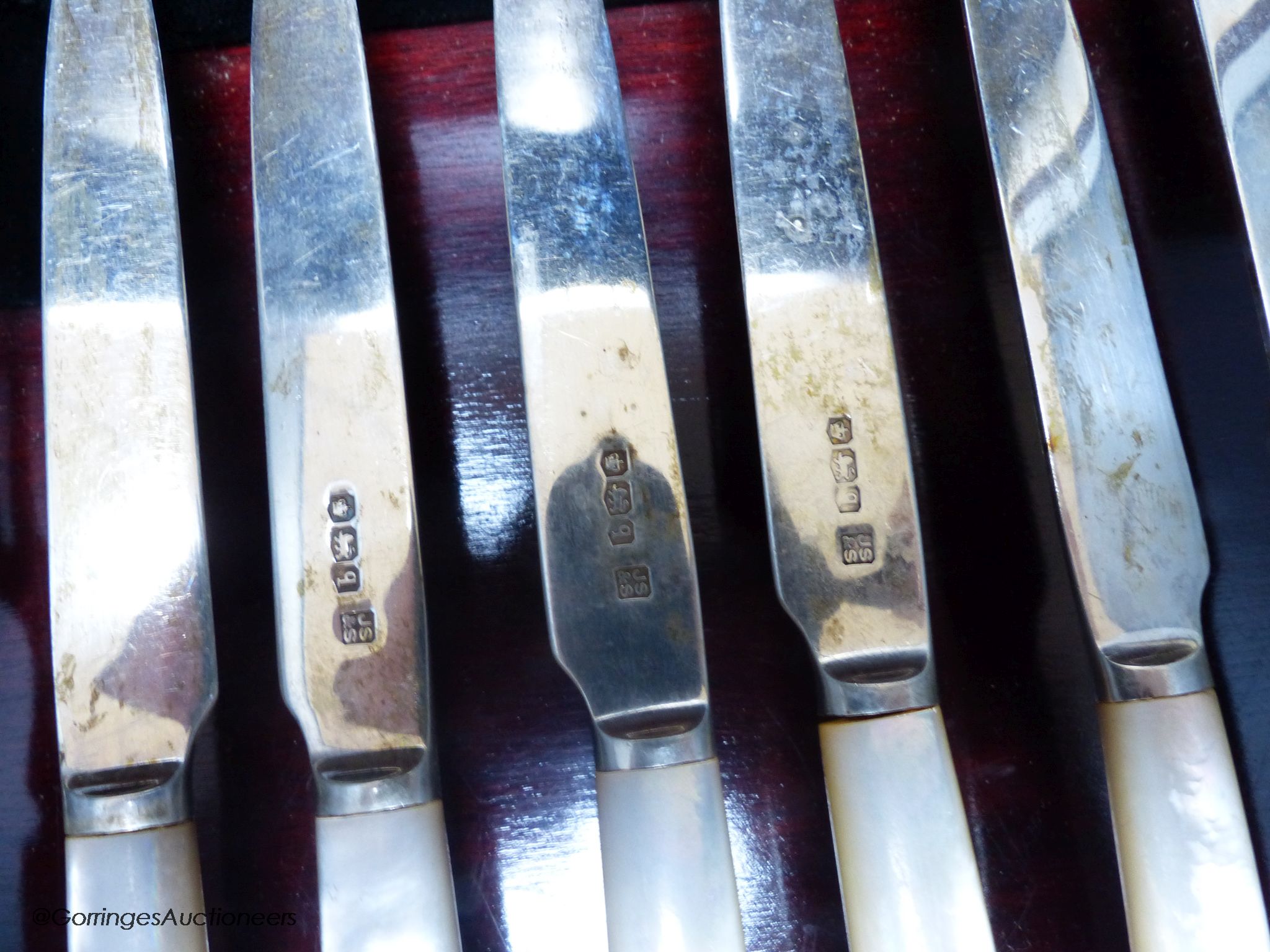 A George V cased set of six pairs of mother of pearl handled silver dessert eaters, Sheffield, 1933.